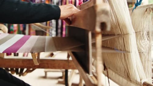 Weaving vibrant textiles by hand in a traditional workshop