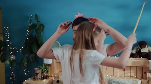 Happy Father and Daughter Dancing in Bedroom