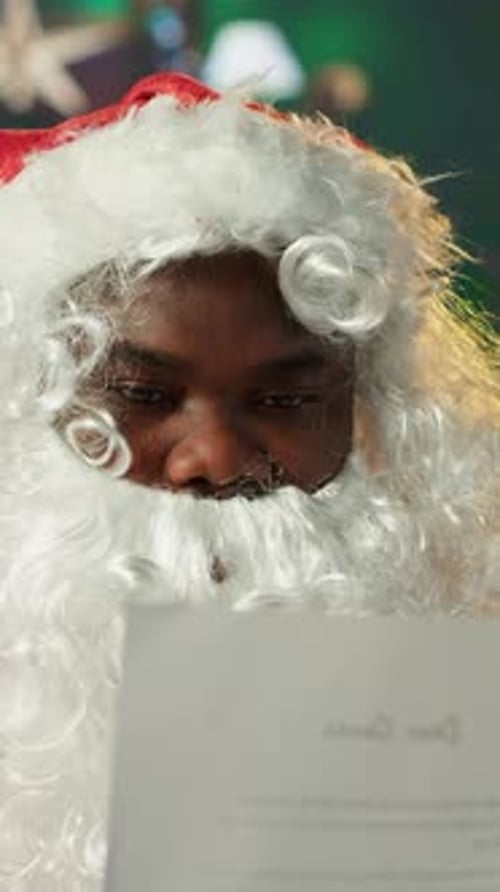 Vertical Video Father Christmas Reading Letters and Lists in His Festive Workshop