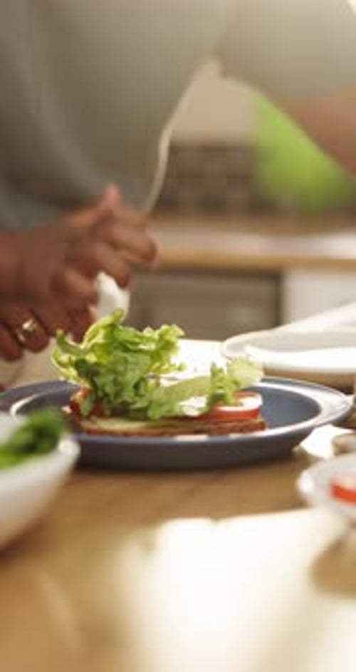 Person Making Sandwich in Bright Kitchen