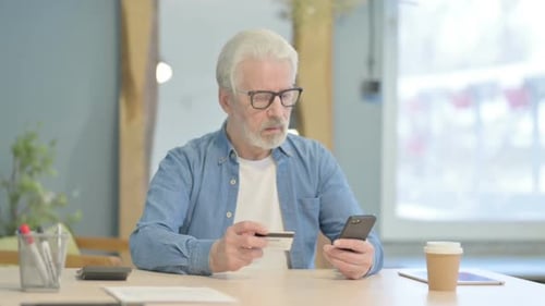 Senior Man Successfully Shops Online with Credit Card
