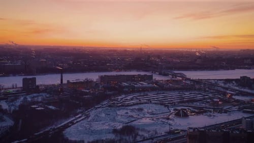 Aerial drone footage of last minutes of a sunset over the city. Golden sky of Saint Petersburg.