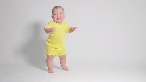 le bébé a appris à se tenir debout et rit fort