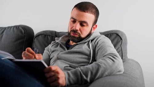 A Middle Eastern Caucasian Man Writing Notes In His Journal - Close Up