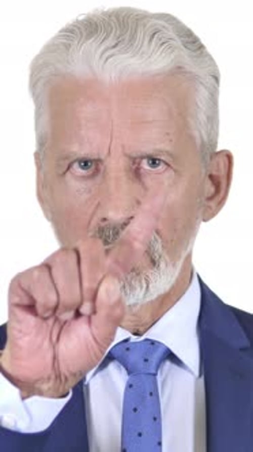 Stern Senior Man in Suit Wags Finger in Disagreement