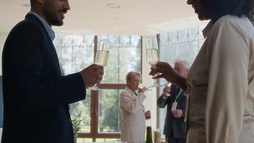 Young Colleagues Clinking Glasses at Business Event