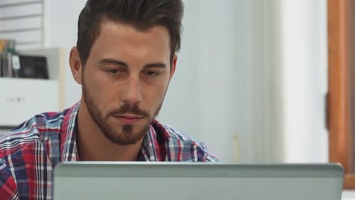 Young Adult Using Laptop Inside During the Day