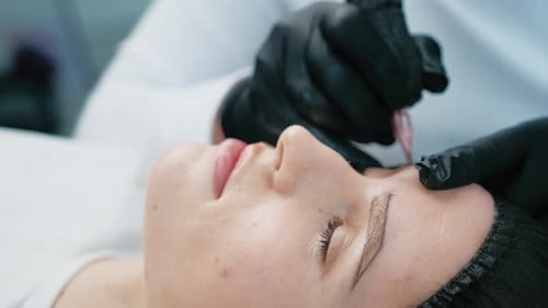 Cosmetologist Making Eyebrow Permanent Makeup