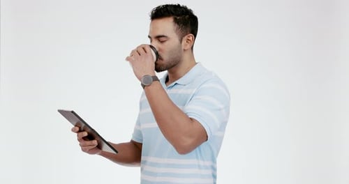 Man, happy and coffee with tablet for social media in studio, ebook and streaming funny movie show