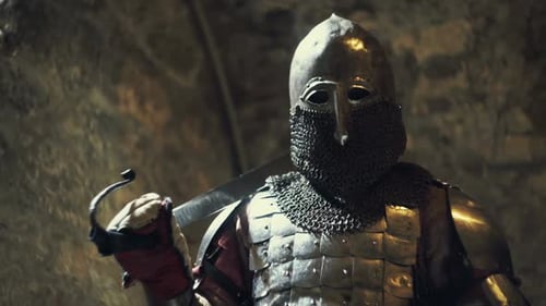 Medieval Knight with the Sword on the Ancient Castle Background