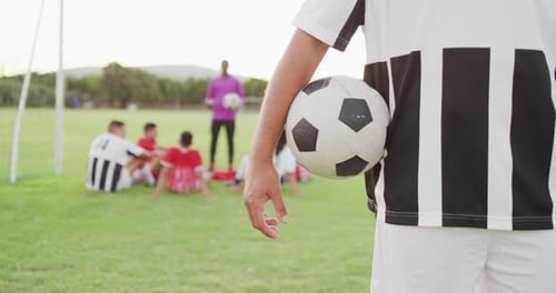 Video of biracial football player on field with ball