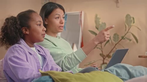 Woman and Child Enjoying Laptop at Home Together