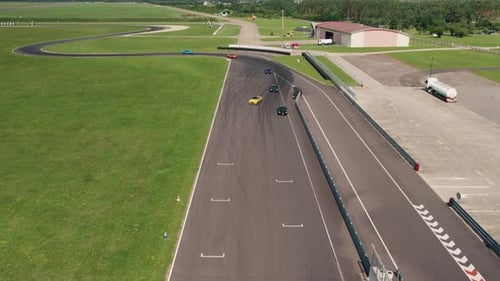 Aerial of Sport Cars during Race on Professional Race Track, Sunny Day, 4k
