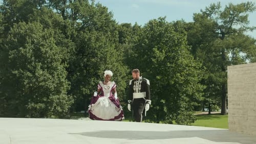 Woman in Victorian Dress and Man in Military Uniform Walking to Royal Palace