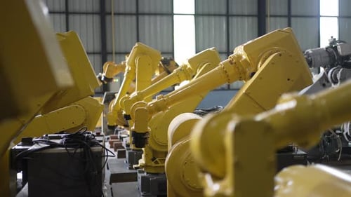 Engineer work at robotic arm factory.
