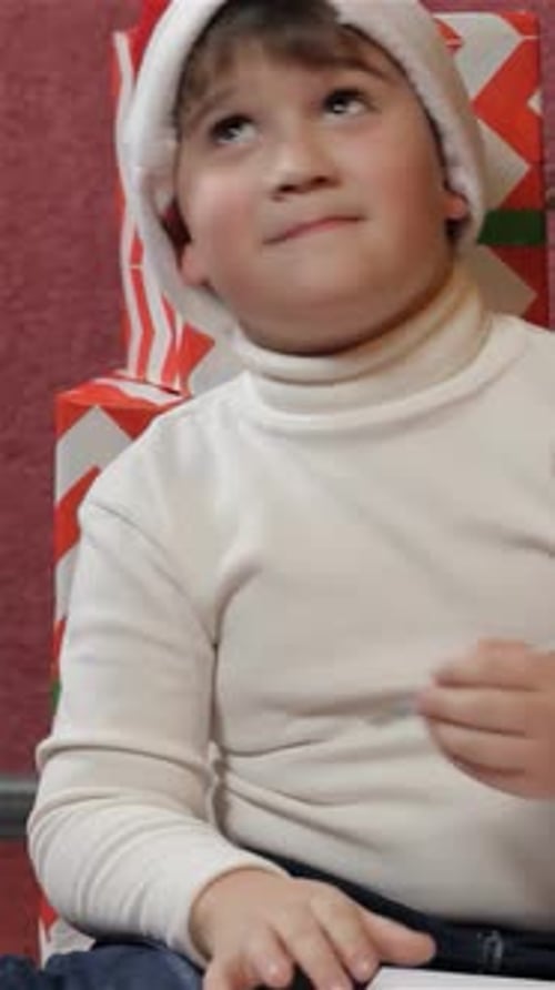 Child Writes Christmas List with Holiday Gifts