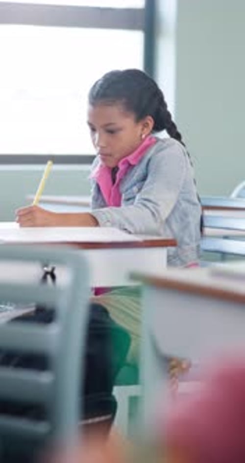 Learning, child and writing test in classroom, development and knowledge with book at school