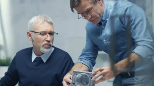 Two Senior Engineers Discuss Important Technical Components, Joining Them Together. Both are Experi