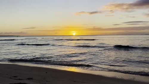 Waves at the beach during sunset, slow motion