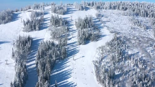 Aerial View of the Winter Mountain Landscape and Ski Lift in Winter Season