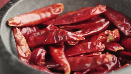 Vibrant Red Dried Chili Peppers in Rustic Bowl