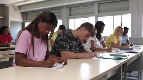 Group of Young Multiracial College Student Doing an Exam at University Classroom
