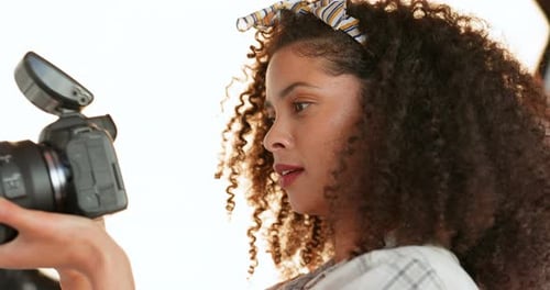 Photographer woman, camera and natural beauty afro of African woman doing a shoot in studio enjoying