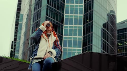 Woman Drinks Coffee in Urban Cityscape