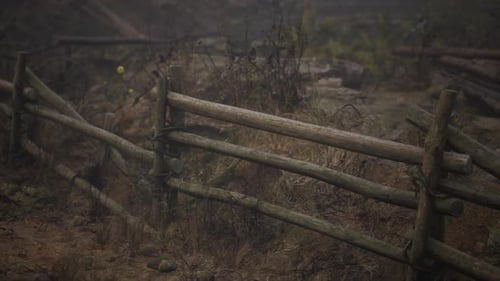 An Old Wood Fence with a Country Field Behind It