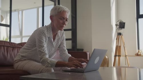 Professional Woman Working on Laptop at Home