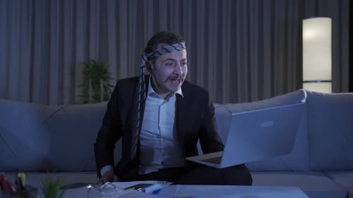 Man Reacts to Laptop News in Living Room