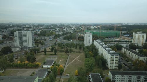 Building a stadium in a big city. Construction site among urban areas. Aerial photography.
