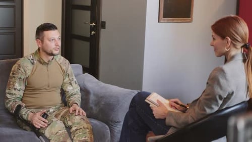 Man in Camo Uniform Talks to Therapist