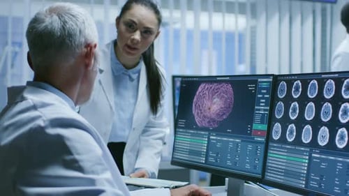 Medical Team Discussing Brain Scans on Computer