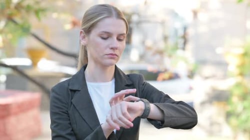 Woman Using Smart Watch in an Urban Setting