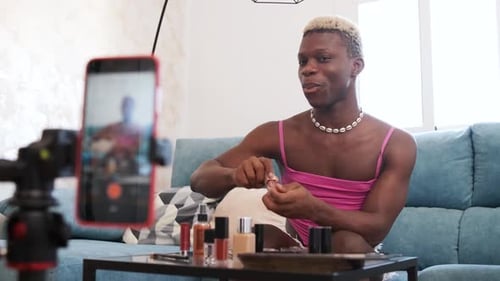 Bloguera de belleza transgénero maquillando la cámara del teléfono móvil