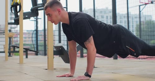 Man Doing Push Up Exercises on Sports Ground Concept of Healthy Lifestyle Outdoors Gym