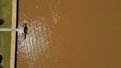 Aerial View of Kayaking in a Brown River