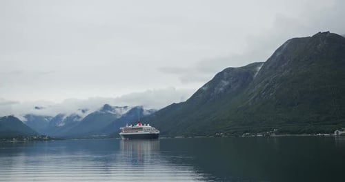 Cruise Ship Sailing Through a Norwegian Fjord with Mountains