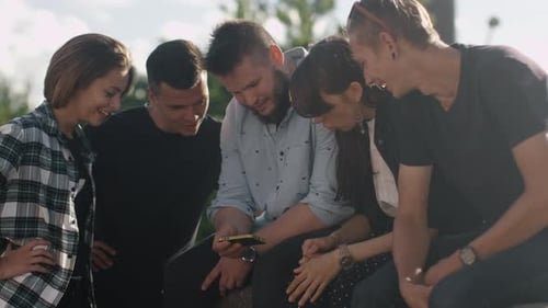 Five Friends Sharing Smartphone Content Outdoors