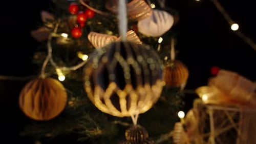 Christmas Ornaments and Gifts on Lit Christmas Tree