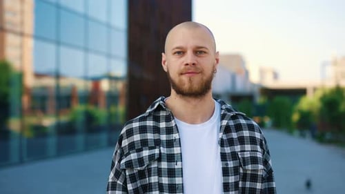 Portrait of the Smiling Bearded Caucasian Man Standing on the Street Looking at the Camera