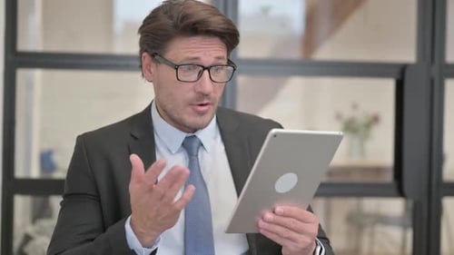 Man Talking During a Video Call on a Tablet