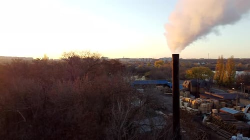 Smoke Comes From the Chimney at the Factory at Sunset Dawn in Autumn
