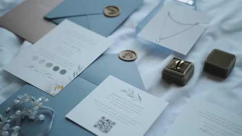 Elegant Wedding Invitation and Rings Close Up