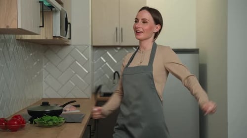 Woman Dancing and Singing in her Kitchen