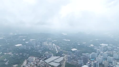 Aerial View Flying Over the Clouds with Stunning Cityscape Below