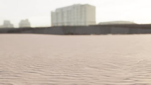 Early Morning Empty Beach Against City Buildings