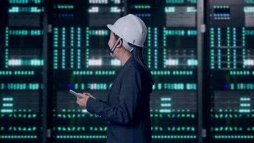 Asian Businesswoman Use Smartphone While Walking and Looking Around in Data Center
