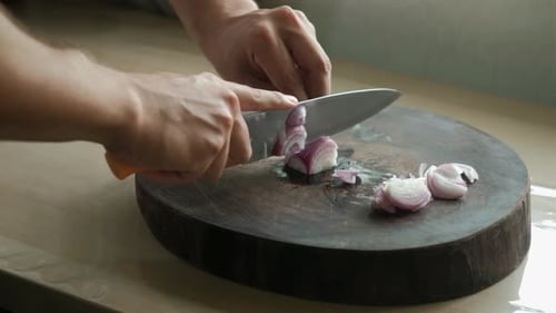 Chopping Red Onions On A Wooden Board. Close-up Shot